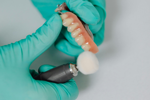 Dentist examining and maintaining a patient's dentures at Lutherville Dental in the Lutherville-Timonium area